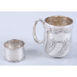 A silver Christening mug with embossed floral decoration and a silver napkin ring, 5.2oz troy