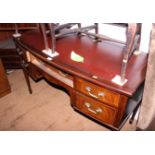 A bowfront mahogany writing table with red inlet top and two frieze drawers, 48" wide