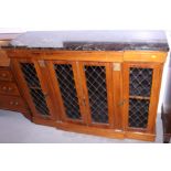 A Regency design rosewood breakfront side cabinet, fitted black marble top over cupboards enclosed