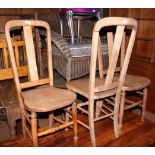 A set of four kitchen chairs with rectangular splats and wooden seats, on turned underframes