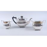 A silver three-piece teaset with gadrooned border and ebonised knop and handle, 44.5oz troy approx