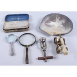 A pair of mother-of-pearl opera glasses, a corkscrew, two magnifying glasses, a shaving strop and