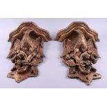 A pair of carved giltwood wall brackets, decorated birds and flowers