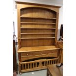 A Lancashire pine "chicken coop" dresser, the upper section fitted open shelves over three drawers