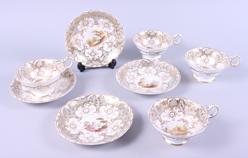 Four 19th century white, grey and gilt decorated cups and saucers, with hand-painted rural scenes to