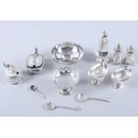 A pair of silver navette-shaped pedestal salts, three silver pepper pots, two silver mustard pots, a