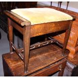 An early 20th century stained wooden box seat piano stool