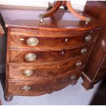 A 19th century mahogany bowfront chest of four graduated drawers with brushing slide, on turned