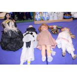 A bisque headed doll dressed as a Pierrot, a mini Pierrot doll and other Continental bisque headed