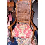 A mahogany framed armchair with carved seat and back (damages to back) and a similar low seat chair