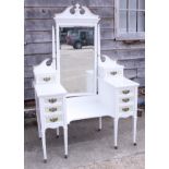 An Edwardian white painted drop centre dressing table, fitted eight drawers, on square taper