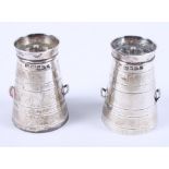 A pair of novelty silver pepper pots, in the form of milk churns