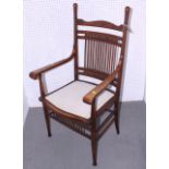 An American open armchair with thirteen spindles to back and wooden seat with upholstered panel