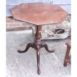 An 18th century mahogany octagonal tilt top occasional table, on turned column and tripod splay