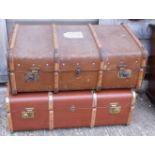 Two steamer trunks and a leather suitcase