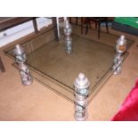 An Indian embossed and enamelled white metal mounted glass two-tier coffee table, 42" square x 19"