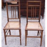 A pair of Edwardian cane seat bedroom chairs and an arch top towel rail