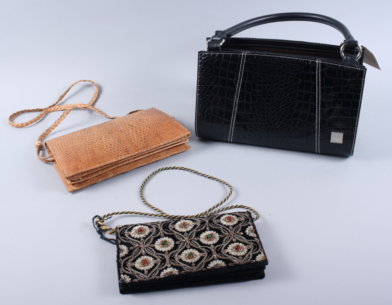 A faux black crocodile handbag and two clutch bags