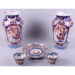 An Imari dish, decorated flowers, 14" dia, a pair of Imari vases, 12" high, and two Imari tea cups