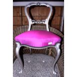 A pair of Victorian silver painted loop back dining chairs, upholstered in a purple fabric