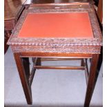 A 19th century Indian rosewood slope top desk with carved borders and inset leather top, on square