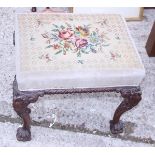 A Georgian design stool, upholstered in a floral gros point, on carved ball and claw supports