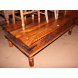 A sheesham hardwood and wrought iron coffee table, fitted four drawers, on turned supports, top