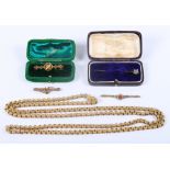 A Victorian gilt muff chain, the clasp formed as a hand, mounted single green stone, a 19th