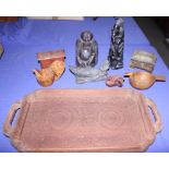 An African carved wooden figure and other assorted wooden ethnographica, on a carved wooden tray