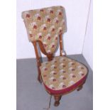 A Victorian beadwork prie-dieu with shaped seat and back, on fluted castored supports