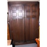 An early 20th century oak wardrobe, on stile supports, 46" wide x 74" high