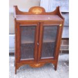 An Edwardian walnut and inlaid wall cupboard enclosed two doors, 29 1/2" wide