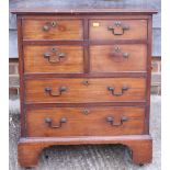 An early 19th century walnut chest of four short and two long graduated drawers with brass side