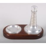 A 1930s turned aluminium lighthouse table lighter and ashtray, on mahogany base, 6" high