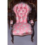 A Victorian showframe armchair, upholstered in a pink floral fabric