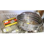 A mirrored oval cake stand with silver plated mounts, a plated swing handled bread basket, a pair of