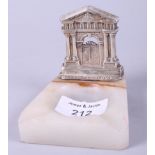 A marble ashtray, mounted with a silver model of Grosvenor House