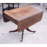 An early 19th century mahogany Pembroke table, fitted one drawer, on turned column and quadruple