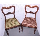 A pair of Victorian mahogany loop back dining chairs with gros point covered seats, on turned