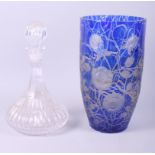 A blue overlaid glass vase with engraved floral decoration and a glass decanter with stopper