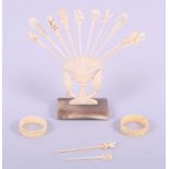 Twelve ivory cocktail sticks and two ivory napkin rings