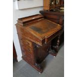 A Victorian mahogany Davenport with false drawers to one side, on castors, 21" wide x 20" deep