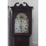 An early 19th century figured mahogany long case clock with painted arch top dial and eight-day