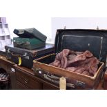 A canvas travelling trunk, a leather suitcase, a shoe case, another case, a fur jacket and two pairs
