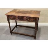 An antique oak side table, fitted one drawer with field panelled front, on bobbin turned and