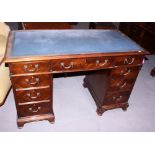 A late 19th century mahogany double pedestal desk with blue leather tool lined top over nine