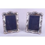 A pair of Carrs embossed silver mounted easel photo frames, 10 1/2" high overall