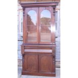 A 19th century mahogany bookcase, the upper section fitted shelves enclosed two arch panel glazed