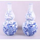 A pair of Chinese blue and white double gourd vases decorated mountainous landscape, prunus and