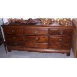An Oriental hardwood triple chest of nine drawers, 70" wide, and a pair of hardwood bedside